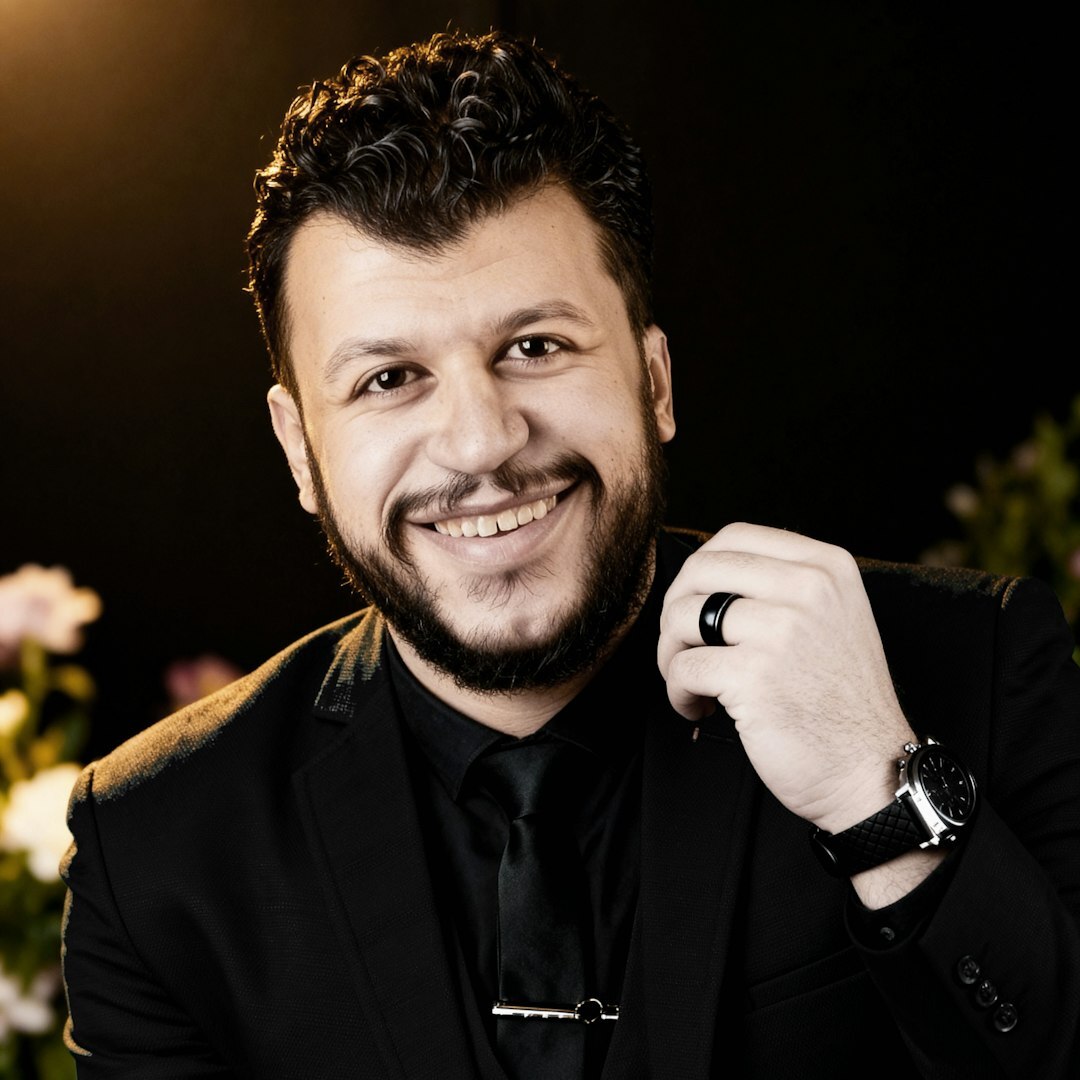 Professional headshot of Belgian male CEO in his 40s with dark hair wearing navy suit